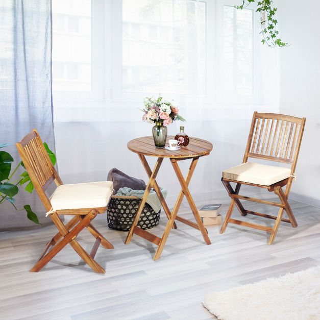 3-piece folding bistro set with beige cushions, made of solid acacia wood, perfect for patio gatherings and. 3-piece folding bistro set with beige cushions, made of solid acacia wood, perfect for patio gatherings and.